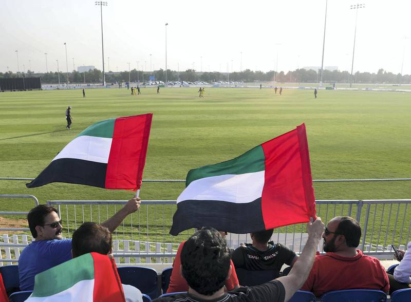 Abu Dhabi, United Arab Emirates - October 22, 2018: UAE fans wave their flags in the match between the UAE and Australia in a T20 international. Monday, October 22nd, 2018 at Zayed cricket stadium oval, Abu Dhabi. Chris Whiteoak / The National