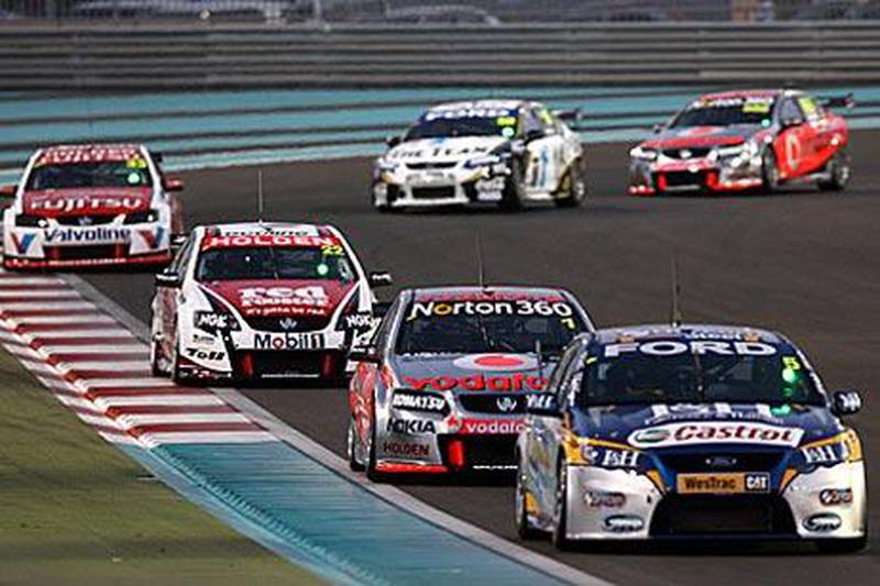 V8 Supercars vie for the lead at  at the Yas Marina Circuit last night.