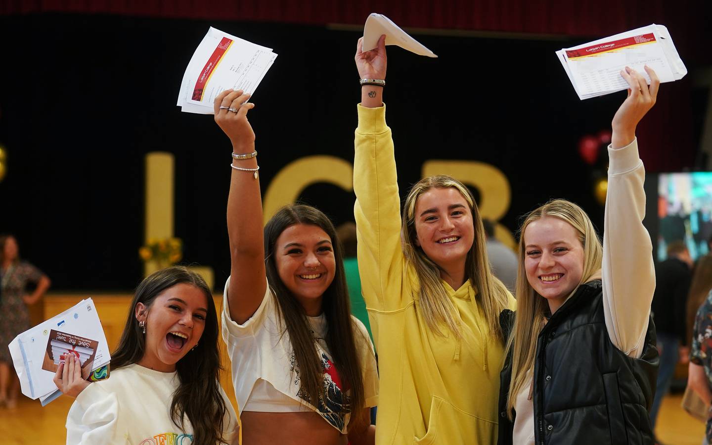 Friends (from left) Katie McCrory, Atlanta Watson, Laura Sharp and Nicole Babb are all smiles after opening their A-level results at Lagan College, Belfast. PA
