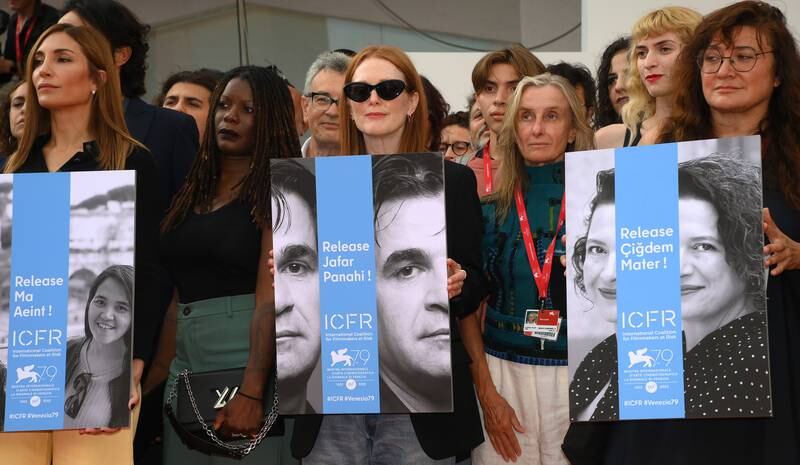 Actress Julianne Moore, centre, led a group of protesters holding posters of Myanmar filmmaker Ma Aeint, Iranian director Jafar Panahi and Turkish producer Cigdem Mater during the 79th Venice Film Festival. EPA
