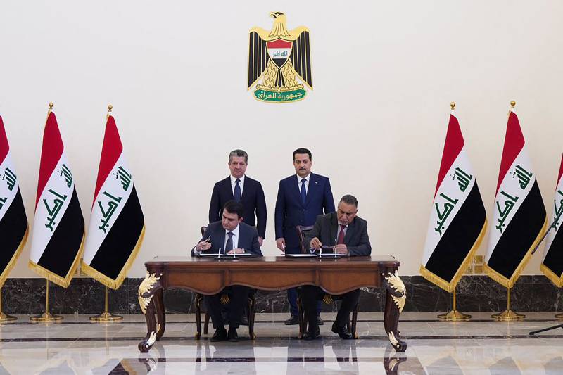 Iraqi Prime Minister Mohammed Shia Al Sudani and KRG Prime Minister Masrour Barzani attending the signing of an oil export deal in Baghdad this week. AFP