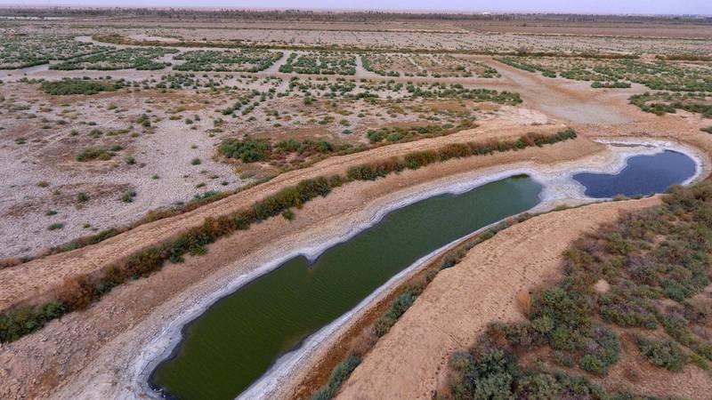 This Saturday, July 28, aerial photo shows a dry canal full of salt in the area of Siba in Basra, 340 miles (550 km) southeast of Baghdad, Iraq. Iraq, historically known as The Land Between The Two Rivers, is struggling with the scarcity of water due to dams in Turkey and Iran, lack of rain and aging hydrological infrastructure. The decreased water levels have greatly affected agriculture and animal resources. (AP Photo/Nabil al-Jurani)