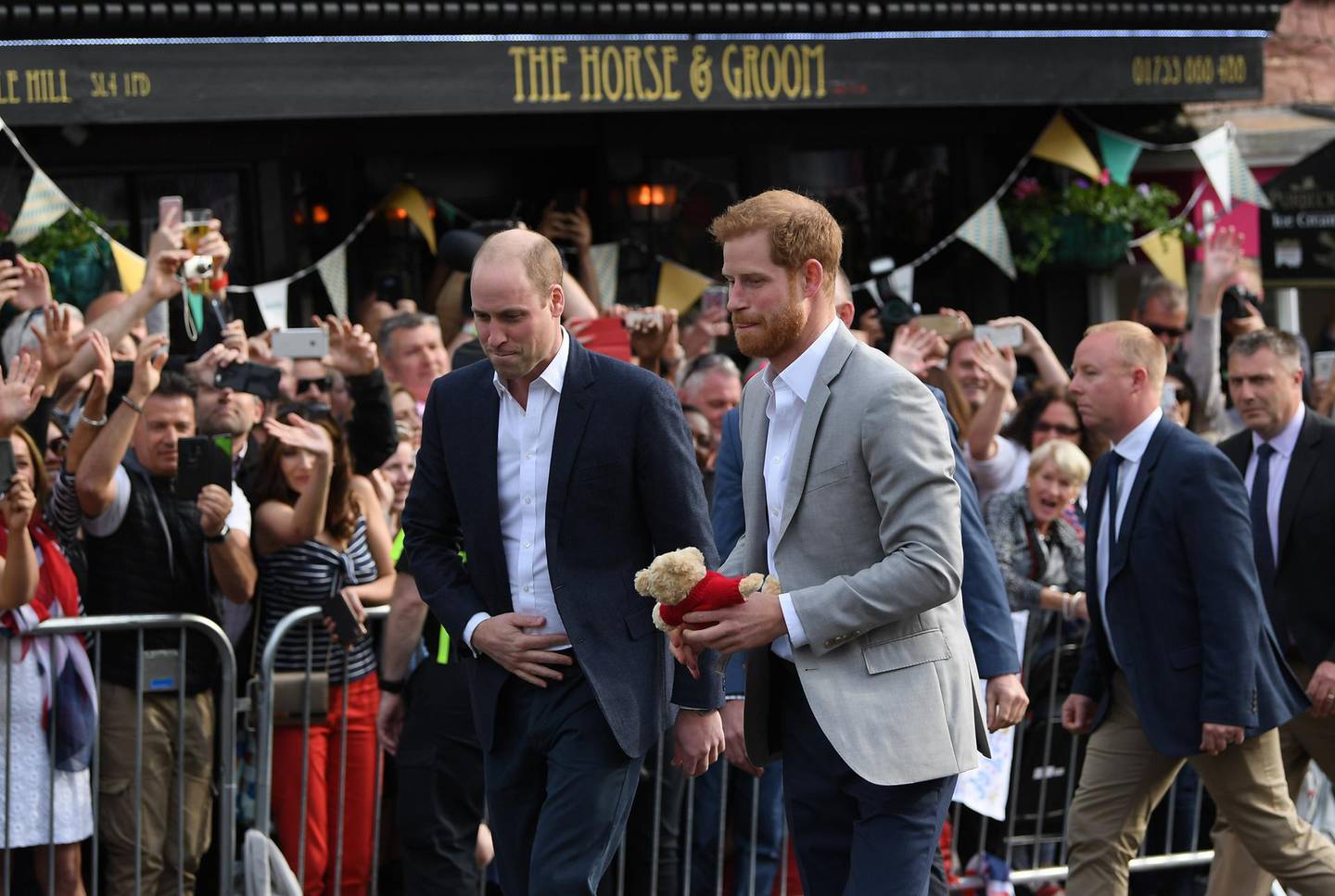 WINDSOR, ENGLAND - MAY 18:  (R-L) Prince Harry and  Prince William, Duke of Cambridge embark on a walkabout ahead of the royal wedding of Prince Harry and Meghan Markle on May 18, 2018 in Windsor, England.  (Photo by Shaun Botterill/Getty Images)