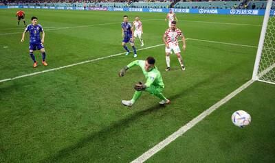 Croatia goalkeeper Dominik Livakovic is beaten by Daizen Maeda's strike for Japan. Reuters