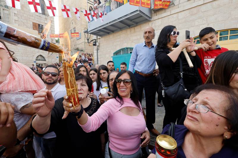 Worshippers attend the 'Holy Fire' ceremony outside the Church of the Nativity in Bethlehem, in the Israeli-occupied West Bank. Reuters