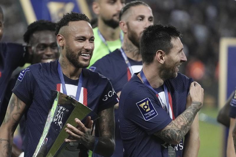 PSG's Neymar, left, holds the trophy as he celebrate with his teammate Lionel Messi after winning the French Super Cup final soccer match between Nantes and Paris Saint-Germain at Bloomfield Stadium in Tel Aviv, Israel, Sunday, July 31, 2022.  PSG won 4-0.  (AP Photo / Ariel Schalit)