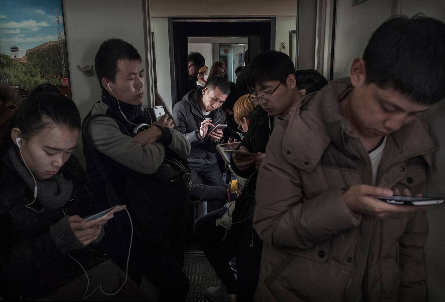 BEIJING, CHINA - JANUARY 25:  Chinese travelers ride in the "standing room" section of a crowded train between Beijing and Shijiazhuang, on January 25, 2017 in Hebei province, northern China. Millions of Chinese will travel home to visit families in what is often called the largest human migration during the Spring Festival holiday period that begins with the Lunar New Year on January 28, 2017.  (Photo by Kevin Frayer/Getty Images)