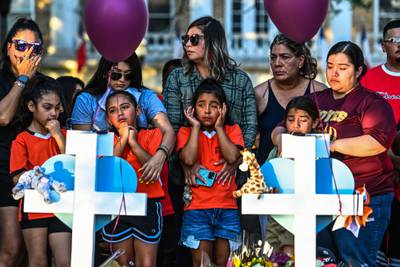 Football teammates of Tess Mata, who died in the Texas school shooting, cry as they visit a makeshift memorial outside the Uvalde County Courthouse.  AFP