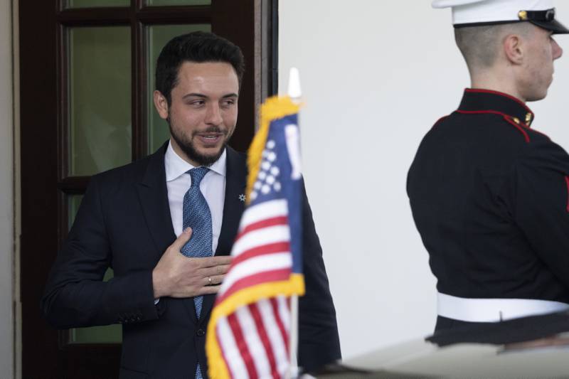 Prince Hussein leaves the White House after a lunch with Mr Biden. AP