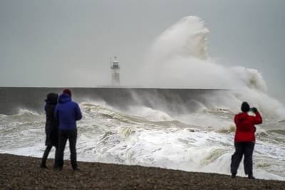 Waves crash over Newhaven lighthouse in East Sussex. More wet and windy weather is set to sweep across the UK. PA