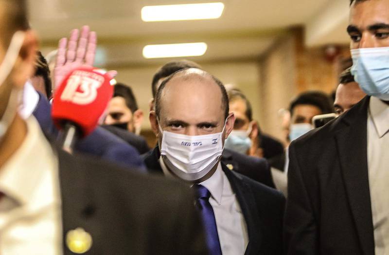 Mr Bennett arrives at the Knesset earlier in the day. AFP