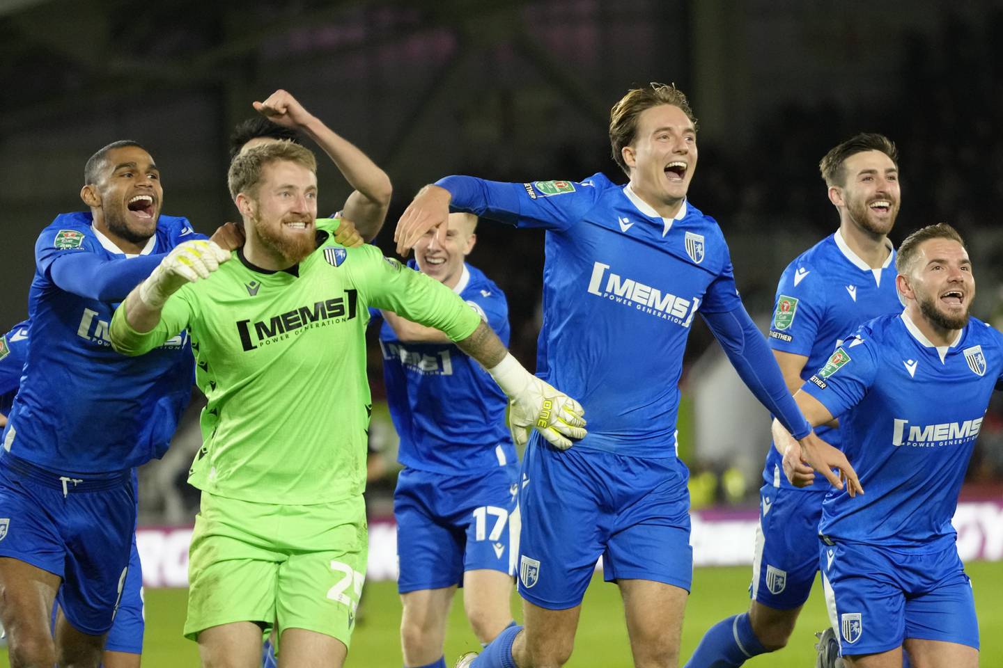 Gillingham players celebrate winning on penalties against Brentford. AP Photo