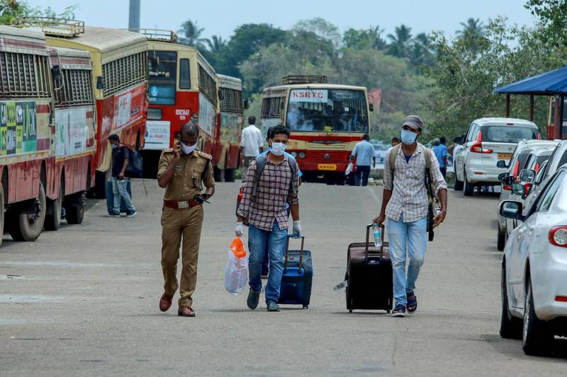 Indian citizens evacuated from Maldives with a special ship INS Jalashwa  are being shifted to a quarantine centre by bus, as part of a massive repatriation effort due to the COVID-19 coronavirus pandemic at the Cochin port in Kochi in the south Indian state of Kerala on May 10, 2020. / AFP / Arunchandra BOSE
