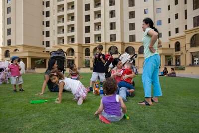 Dubai, UAE - June 18, 2009 - Nannies play with their children on a patch of grass between buildings in Jumeirah Beach Residences. (Nicole Hill / The National) *** Local Caption ***  NH Stock06.jpgNH Stock06.jpgNH Stock06.jpg