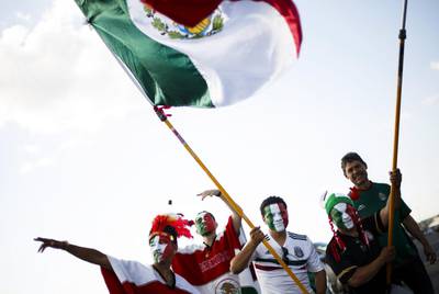 Fans of the Mexican national team carry large national flags in a parking lot before the start of the friendly match between Mexico and Ireland at MetLife Stadium in East Rutherford, New Jersey, US. Justin Lane / EPA