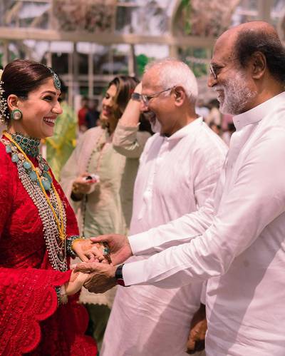 South Indian superstar Rajinikanth greets Nayanthara. Acclaimed director Mani Ratnam can also be seen in the background.