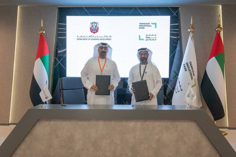Arafat Al Yafei, left, executive director of Added’s Industrial Development Bureau, and Faiz Al Nahddy, managing director and chief executive of Tawazun Industrial Park, sign an agreement to boost the industrial sector. Photo: Added