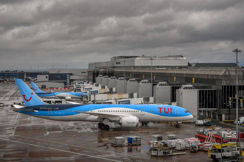 Aircraft operated by TUI are pictured at Manchester Airport in Manchester, north west England on July 27, 2020, following the holiday operator's decision to cancel all holidays to mainland Spain, due to a spike in the number of COVID-19 cases there. Tour operator TUI has cancelled all British holidays to mainland Spain from Monday until August 9, after the UK government's decision to require travellers returning from the country to quarantine. The newly-imposed rule to self-isolate, abruptly introduced at midnight Saturday hours after being announced, follows a surge in novel coronavirus cases in parts of Spain in recent weeks. / AFP / Anthony Devlin
