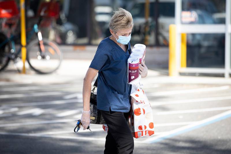 A member of the public is seen wearing a face mask and holding their groceries in Perth, Australia. Getty Images