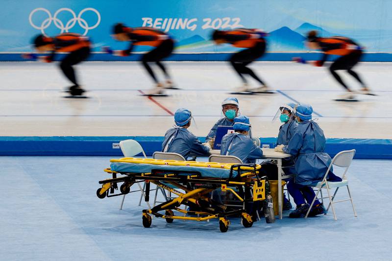 Medical staff in protective equipment are seen during a speed-skating training session for the Beijing 2022 Winter Olympics in Beijing, on January 28, 2022. Reuters