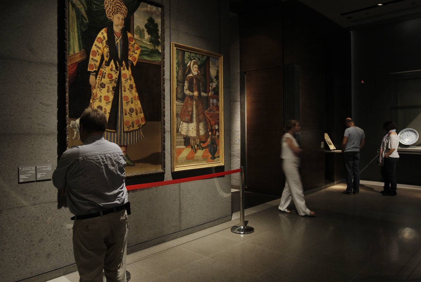 DOHA, QATAR - February 18, 2009: A visitor looks at 17th century oil paintings from Iran while other visitors tour the Museum of Islamic Art on the corniche of Doha, Qatar  (Ryan Carter / The National)



*** For Travel story by Mo Gannon 

 *** Local Caption ***  RC029-TravelDoha.jpgRC029-TravelDoha.jpg