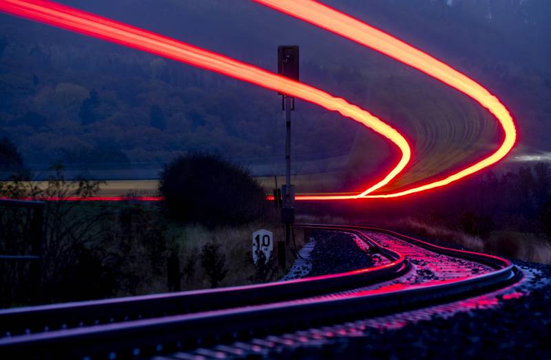 A long-exposure photo shows a train approaching the station in Wehrheim, Germany. AP