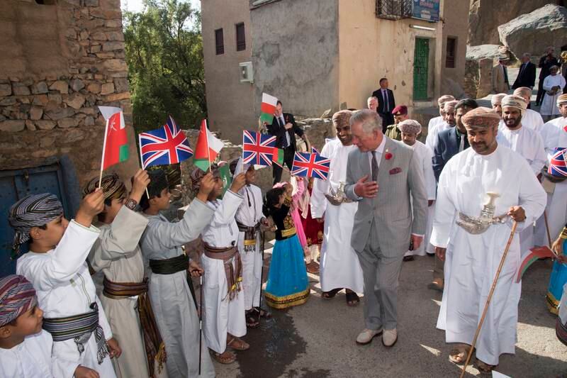 Prince Charles is accompanied by a local guide and a representative from the Ministry of Tourism during a walking tour in Muscat, Oman, in 2016. Getty