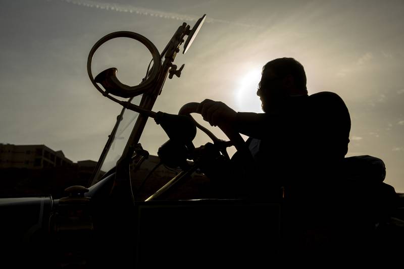 The vintage car collector is silhouetted in his 1924 Ford T.