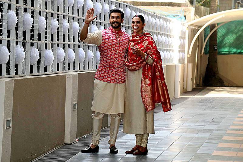 Indian Bollywood actors and recently-wedded couple Ranveer Singh (L) and Deepika Padukone pose after arriving at their residence in Mumbai on November 18, 2018 after being married in Lake Como. Photo / AFP
