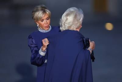 Ms Macron welcomes Queen Camilla to the Palace of Versailles. Reuters