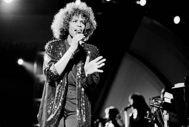Whitney Houston performs onstage at Jones Beach, New York in 1982. Getty Images. 