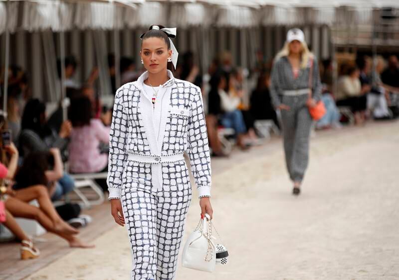 As part of the Chanel cruise 2022/23 collection, the famous house tweed patterning has been rethought to echo the chequered flag of the Grand Prix. Photo: EPA