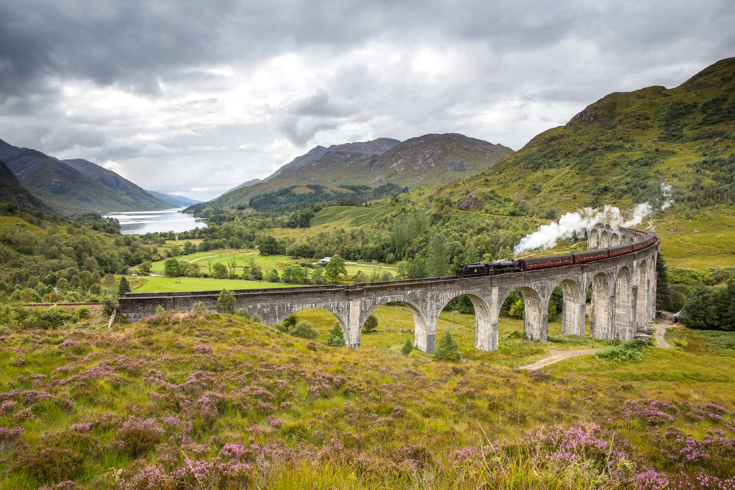 The Jacobite steam train passing over the Glenfinnan Viaduct at the head of Loch Shiel, Lochaber, Highlands of Scotland