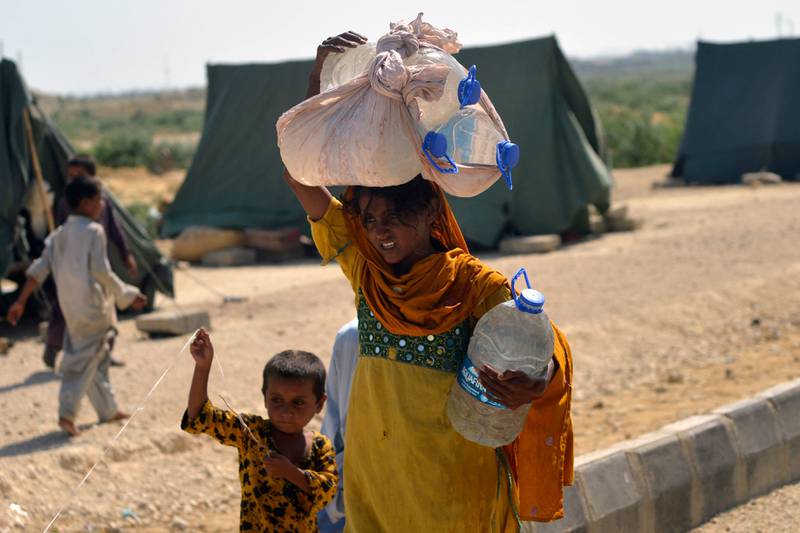 An internally displaced woman collecting drinking water in Jamshoro district of Pakistan's Sindh province. Flooding that submerged one third of the country and killed more than 1,000 people has piled pressure on its faltering economy. AFP
