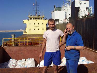 Boris Prokoshev, right, captain of the Rhosus, and boatswain Boris Musinchak pose next to a freight hold loaded with ammonium nitrate in the port of Beirut in 2014. Boris Musinchak / Reuters