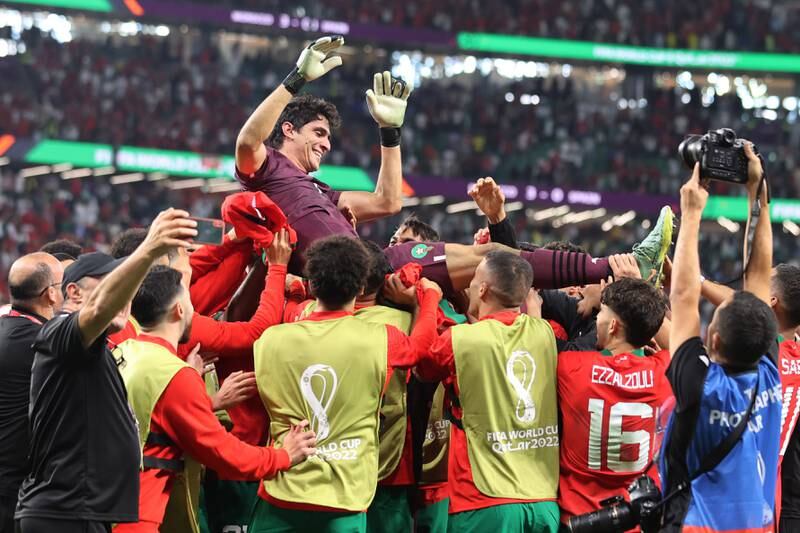 Morocco players celebrate with goalkeeper Yassine Bounou after his penalty shoot-out heroics against Spain.