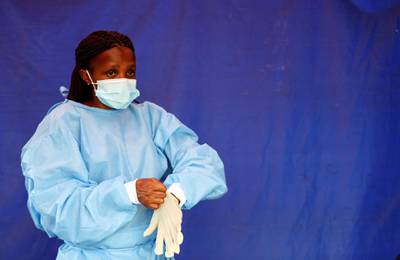 A health worker wears protective clothing as she prepares to test travellers at the Grasmere Toll Plaza, in Lenasia, South Africa. Reuters