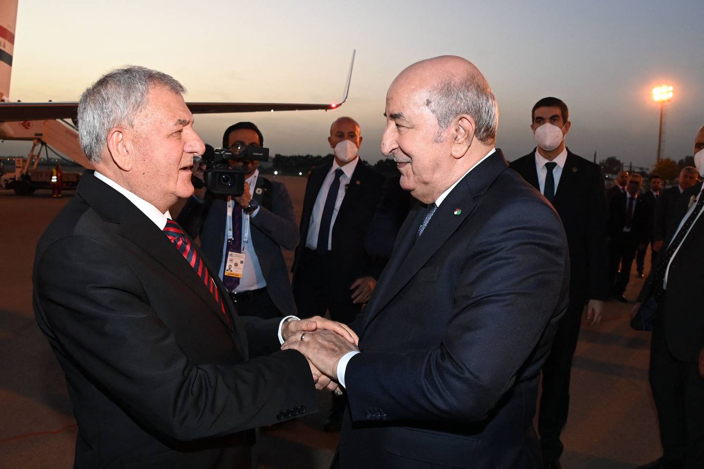 Algerian President Abdelmadjid Tebboune, left, welcomes Iraq's President Abdul Latif Rashid. AFP
