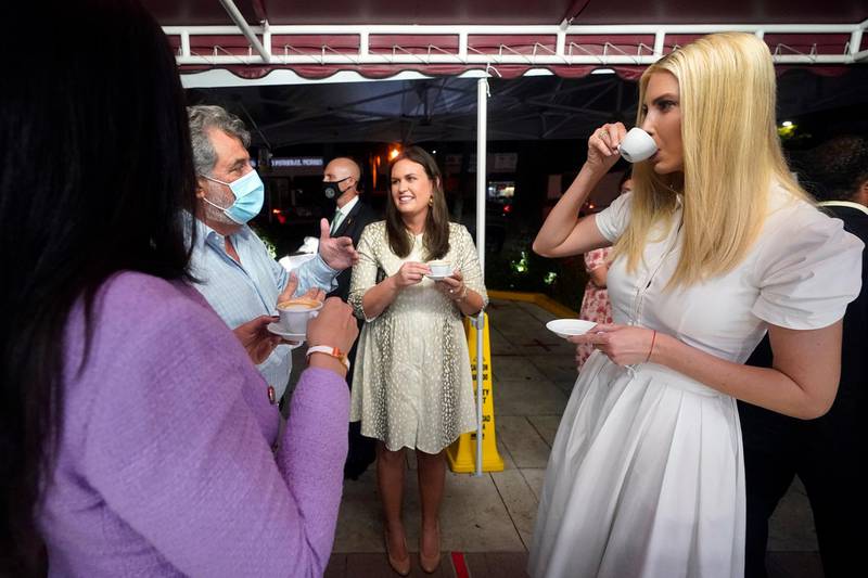 Ivanka Trump, right, shares a Cuban coffee with former White House press secretary Sarah Sanders, second from right, Felipe Valls Jr., second from left, owner of Versailles Cuban restaurant, and his daughter Nicole, left, in the Little Havana neighborhood in Miami, Florida. AP Photo