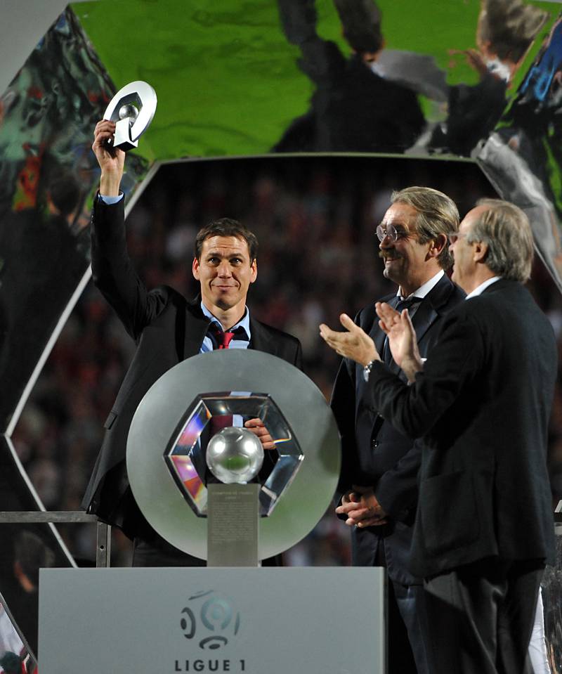 Lille's French coach Rudi Garcia celebrates with L1 title's trophy on May 29, 2011. AFP