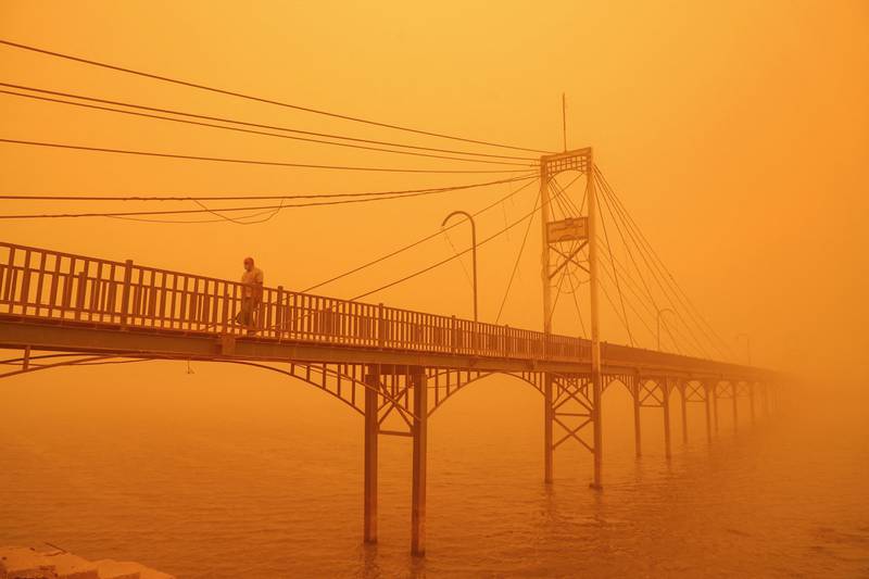 A man walks along the Euphrates river in Nasiriyah in Iraq's southern Dhi Qar province during a heavy dust storm. AFP