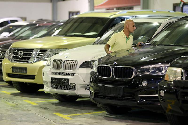 DUBAI , UNITED ARAB EMIRATES , JULY 10 – 2018 :- Car dealer checking the cars before the start of live car auction held at Pioneer Auctions in Umm Ramool area near the Dubai International Airport in Dubai. Pioneer Auctions is the leading live auction house in Dubai and has been holding car & vehicle auctions in the UAE for over 10 years. Over that time they have sold over 11,000 cars at live auction, from Ferraris to Fords, Classics to exotics. Pioneer auction also works with Dubai Customs, Dubai Police and other companies. ( Pawan Singh / The National )  For Photo Project