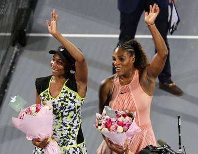 Venus Williams, left, celebrates her success against sister Serena, right, at the Mubadala World Tennis Championship. AP Photo