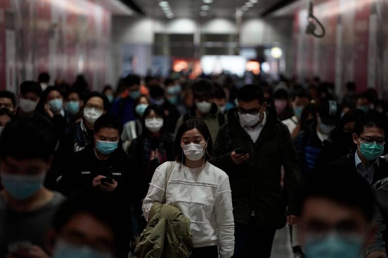 People wearing masks, walk in a subway station, in Hong Kong, Friday, Feb. 7, 2020. Hong Kong on Friday confirmed 25 cases of a new virus that originated in the Chinese province of Hubei. According to the latest figures, 233 new cases of the novel coronavirus have been confirmed globally, Hong Kong's Chief Secretary for Admissions told a news conference. (AP Photo/Kin Cheung)