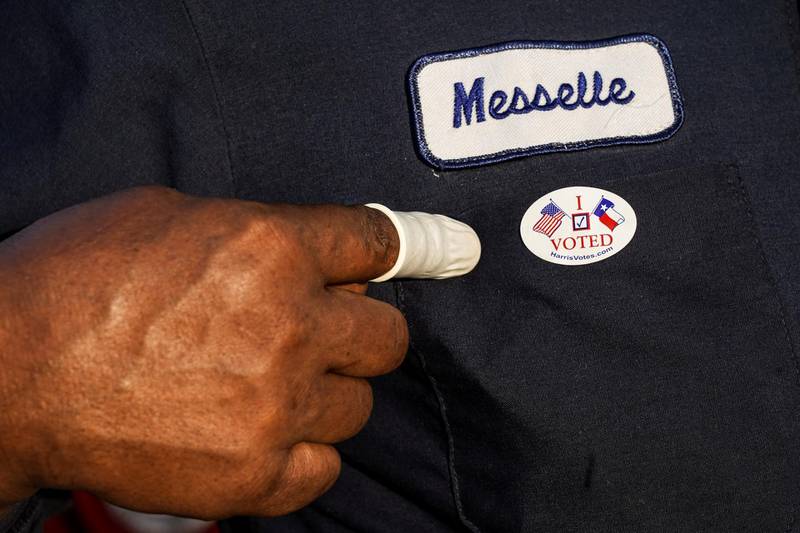 A person wearing a finger sack points at an "I Voted" sticker after casting ballot for the upcoming presidential election as early voting begins in Houston, Texas, U.S. REUTERS