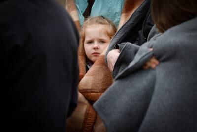 A child who fled from Ukraine to Belgium waits outside an immigration office in Brussels. EPA