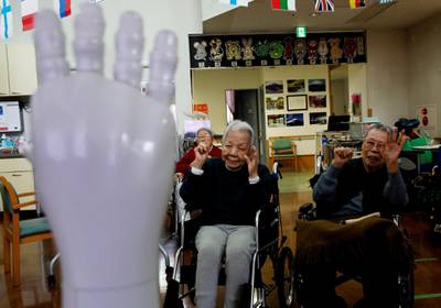 Residents follow moves made by humanoid robot 'Pepper' during an afternoon exercise routine at Shin-tomi nursing home in Tokyo, Japan, February 2, 2018. REUTERS/Kim Kyung-Hoon  SEARCH "KYUNG-HOON ROBOTS" FOR THIS STORY. SEARCH "WIDER IMAGE" FOR ALL STORIES.