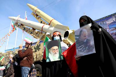 Iranian women hold pictures of the Supreme Leader Ayatollah Ali Khamenei and the late Iranian Major General Qassem Soleimani. WANA via REUTERS