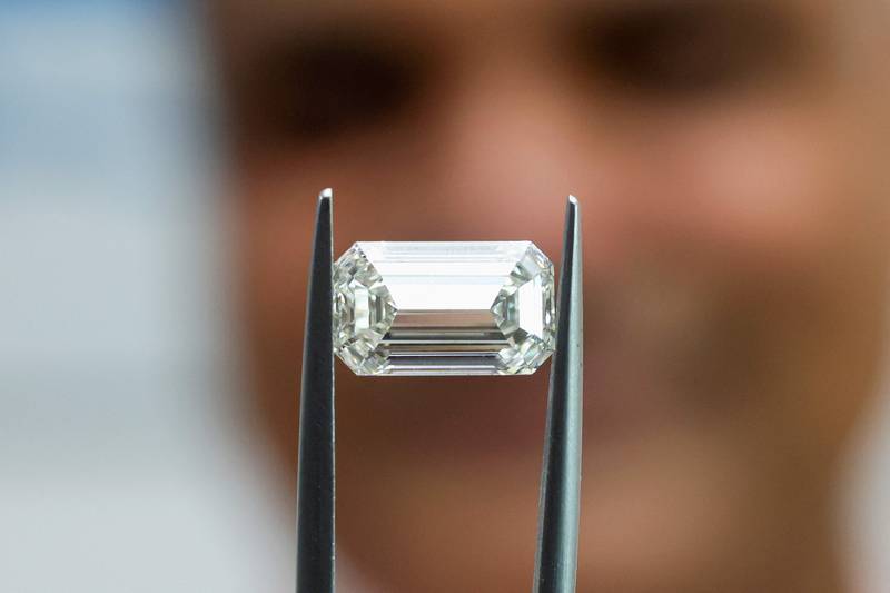 Pravin Kukadia, Director of Eminent Gems LTD, displays a diamond to AFP during an interview at his office in the Israel World Diamond Center in the city of Ramat Gan city on the outskirts of Tel Aviv on May 16, 2022.  - Israel's Diamond Exchange is home to some 30 Indian companies, making India -- the world's largest diamond polisher -- the foreign country with the biggest number of firms in the bourse.  (Photo by JACK GUEZ  /  AFP)