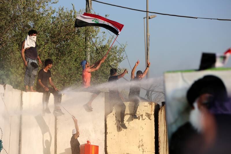 Anti-riot policemen use water cannons in a bid to disperse supporters of Mr Al Sadr. EPA